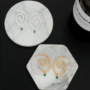 Spiral earrings with green rhinestone accent